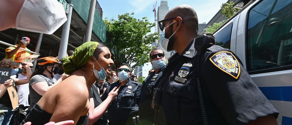 Protesters react after NYPD officers arrest a man for unknown reasons during a "Black Trans Lives Matter" march against police brutality on June 17, 2020 in the Brooklyn Borough of New York City. (Photo by ANGELA WEISS/AFP via Getty Images)