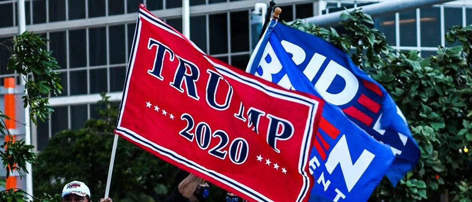Supporters of US President Donald Trump and Democratic presidential nominee and former Vice President Joe Biden wave flags prior to Biden's arrival for an NBC townhall outside of the Perez Art Museum in Miami, Florida on October 5, 2020. (Photo by Chandan Khanna/AFP via Getty Images)