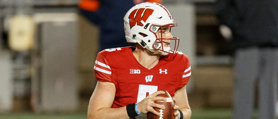 Oct 23, 2020; Madison, Wisconsin, USA; Wisconsin Badgers quarterback Graham Mertz (5) looks to throw a pass during the third quarter against the Illinois Fighting Illini at Camp Randall Stadium. Mandatory Credit: Jeff Hanisch-USA TODAY Sports via Reuters