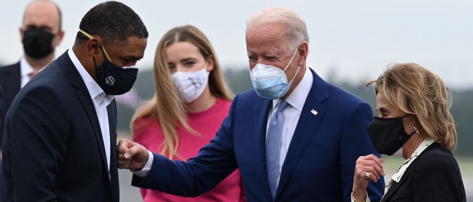Democratic Presidential Candidate Joe Biden is greeted by US Congressman Cedric Richmond, D-LA, as he arrives with his granddaughter Finnegan Biden(2ndL) and his sister Valerie Biden Owens(R) in Columbus, Georgia, on October 27, 2020. (Photo by JIM WATSON/AFP via Getty Images)