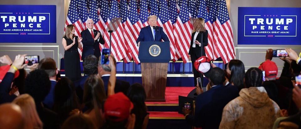 US President Donald Trump, flanked by Karen Pence (L), US Vice President Mike Pence (2nd L) and US First Lady Melania Trump (R), speaks during election night in the East Room of the White House in Washington, DC, early on November 4, 2020. (Photo by MANDEL NGAN/AFP via Getty Images)
