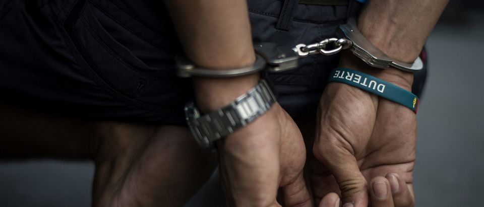 An alleged drug dealer is captured by policemen after a drug buy-bust operation on a slum area in Manila on September 28, 2017. Nearly half of Filipinos believe police are killing innocent people in waging President Rodrigo Duterte's anti-drugs war, according to survey results released Wednesday. (Photo credit should read Noel Celis/AFP via Getty Images)