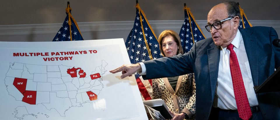 WASHINGTON, DC - NOVEMBER 19: Rudy Giuliani points to a map as he speaks to the press about various lawsuits related to the 2020 election, inside the Republican National Committee headquarters on November 19, 2020 in Washington, DC. President Donald Trump, who has not been seen publicly in several days, continues to push baseless claims about election fraud and dispute the results of the 2020 United States presidential election. Also pictured, at center, is attorney Sidney Powell. (Photo by Drew Angerer/Getty Images)