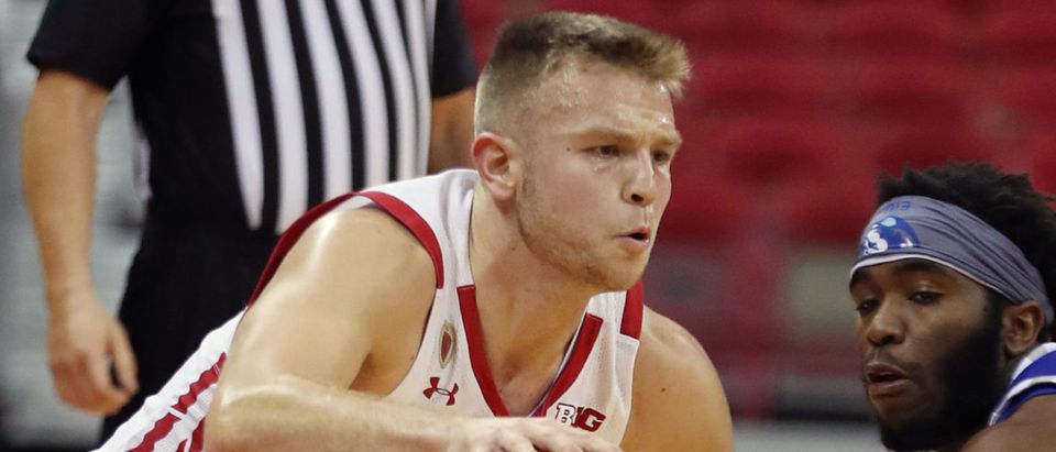 Nov 25, 2020; Madison, Wisconsin, USA; Wisconsin Badgers guard Brad Davison (34) drives against Eastern Illinois Panthers guard Kashawn Charles (1) at the Kohl Center. Mandatory Credit: Mary Langenfeld-USA TODAY Sports via Reuters