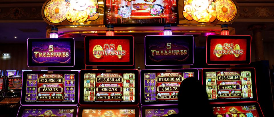 A woman uses slot machines at the Dragonara Casino in St Julian's