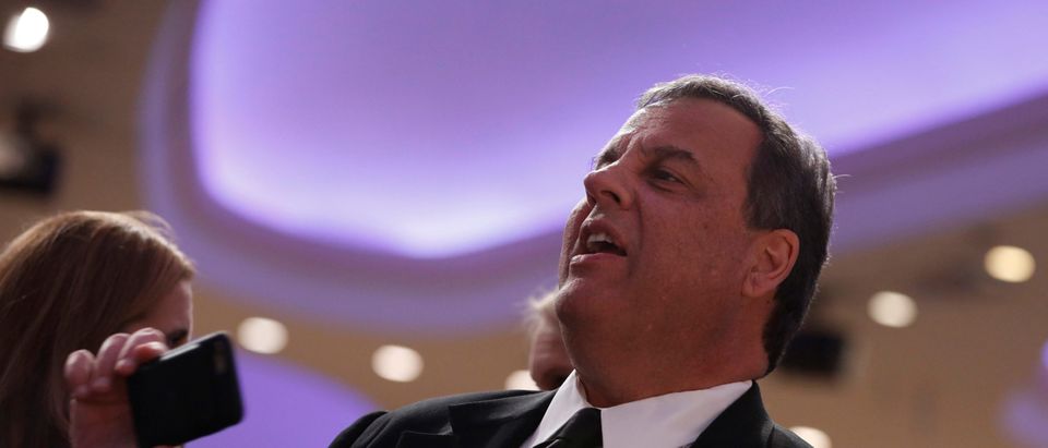 Former New Jersey Governor Christie takes a photo at the White House Correspondents' Association dinner in Washington