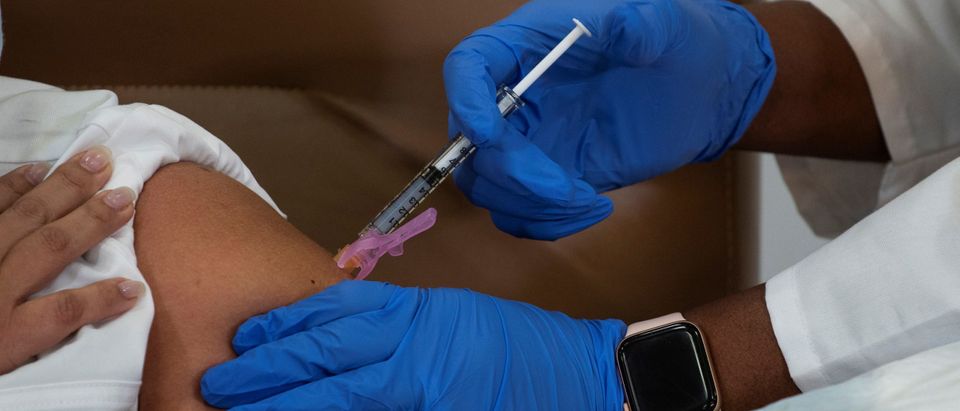 Healthcare workers receive the Moderna COVID-19 vaccine