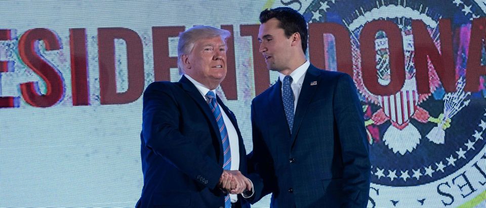 US President Donald Trump shakes hands with Charlie Kirk, head of Turning Point USA, before addressing the Turning Point USAs Teen Student Action Summit in Washington, DC, on July 23, 2019. (NICHOLAS KAMM/AFP via Getty Images)