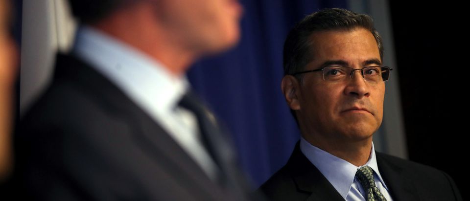 SACRAMENTO, CALIFORNIA - SEPTEMBER 18: California attorney general Xavier Becerra (R) looks on as California Gov. Gavin Newsom speaks during a news conference at the California justice department on September 18, 2019 in Sacramento, California. California Gov. Gavin Newsom, California attorney general Xavier Becerra and California Air Resources Board Chair Mary Nichols held a news conference in response to the Trump Administration's plan to revoke California’s waiver to establish vehicle emissions standards for greenhouse gas emissions and standards to require manufacturers to sell zero emissions vehicles. Under the federal Clean Air Act, California is allowed to set its own vehicle emissions standards that are at least as protective as the federal government’s standards. The state has received 100 waivers from the Environmental Protection Agency (EPA) for higher standards than federally mandated over the past 50 years. (Justin Sullivan/Getty Images)