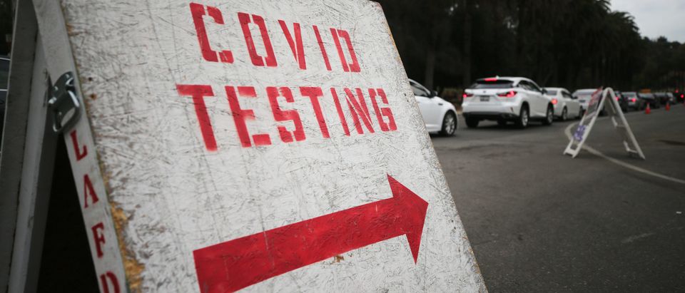 LOS ANGELES, CALIFORNIA - DECEMBER 07: Vehicles line up to enter a COVID-19 testing site at Dodger Stadium on the first day of new stay-at-home orders on December 7, 2020 in Los Angeles, California. Under state order, 33 million residents of California have entered into regional shutdowns in an attempt to contain the spread of the coronavirus as ICU capacity has dipped below 15 percent in most regions of the state. Barbershops, hair and nail salons, museums, zoos, movies theaters are closed while restaurants are open for takeout or delivery only. (Mario Tama/Getty Images)