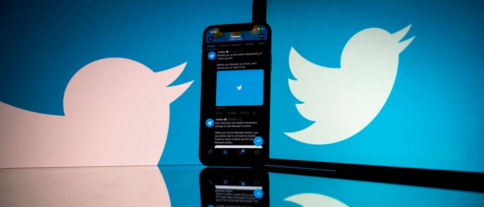 This photograph taken on October 26, 2020 shows the logo of US social network Twitter displayed on the screen of a smartphone and a tablet in Toulouse, southern France. (Photo by Lionel Bonaventure/AFP via Getty Images)
