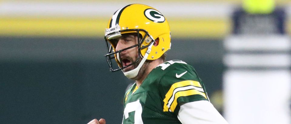 Jan 16, 2021; Green Bay, Wisconsin, USA; Green Bay Packers quarterback Aaron Rodgers (12) celebrates a touchdown against the Los Angeles Rams during the NFC Divisional Round at Lambeau Field. Mandatory Credit: Mark J. Rebilas-USA TODAY Sports via Reuters