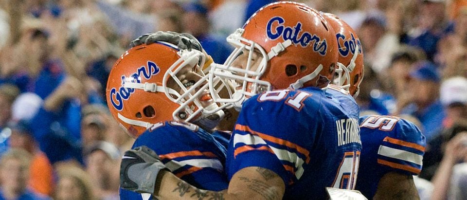 Florida quarterback Tim Tebow (L) hugs Aaron Hernandez after a five-yard touchdown catch against South Carolina during the fourth quarter of their NCAA college football game in Gainesville, Florida, November 15, 2008. REUTERS/Steve Nesius (UNITED STATES)