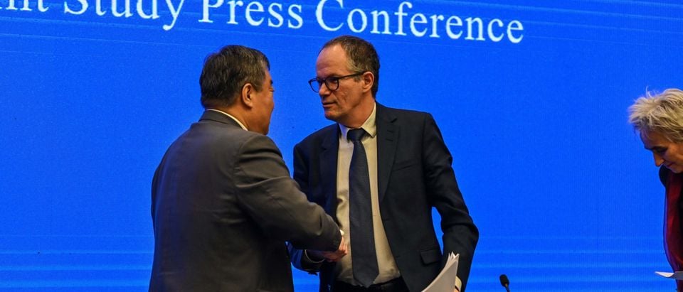 Peter Ben Embarek (R) shakes hands with Liang Wannian (L) after a press conference following a visit by the international team of experts from the World Health Organization (WHO) in the city of Wuhan, in China's Hubei province on February 9, 2021. (Photo by Hector RETAMAL / AFP) (Photo by HECTOR RETAMAL/AFP via Getty Images)