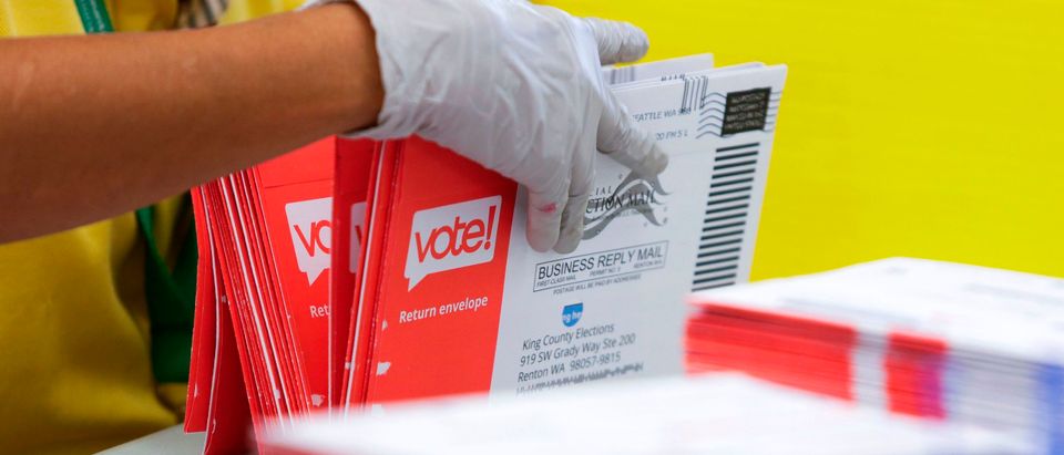 Election worker opens envelopes with vote-by-mail ballots