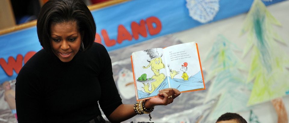 US First Lady Michelle Obama reads the c