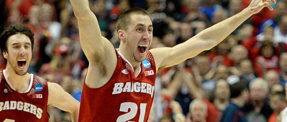 ANAHEIM, CA - MARCH 29: Josh Gasser #21 and Frank Kaminsky #44 of the Wisconsin Badgers celebrate after defeating the Arizona Wildcats 64-63 in overtime during the West Regional Final of the 2014 NCAA Men's Basketball Tournament at the Honda Center on March 29, 2014 in Anaheim, California. (Photo by Harry How/Getty Images)
