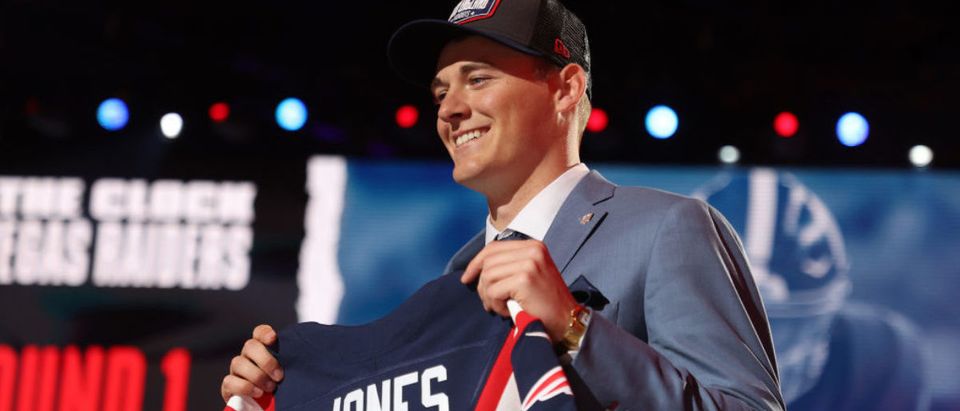 CLEVELAND, OHIO - APRIL 29: Mac Jones poses onstage after being selected 15th by the New England Patriots during round one of the 2021 NFL Draft at the Great Lakes Science Center on April 29, 2021 in Cleveland, Ohio. (Photo by Gregory Shamus/Getty Images)
