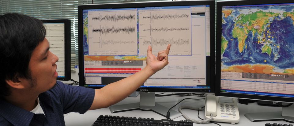 Seismologist observing earthquake readings