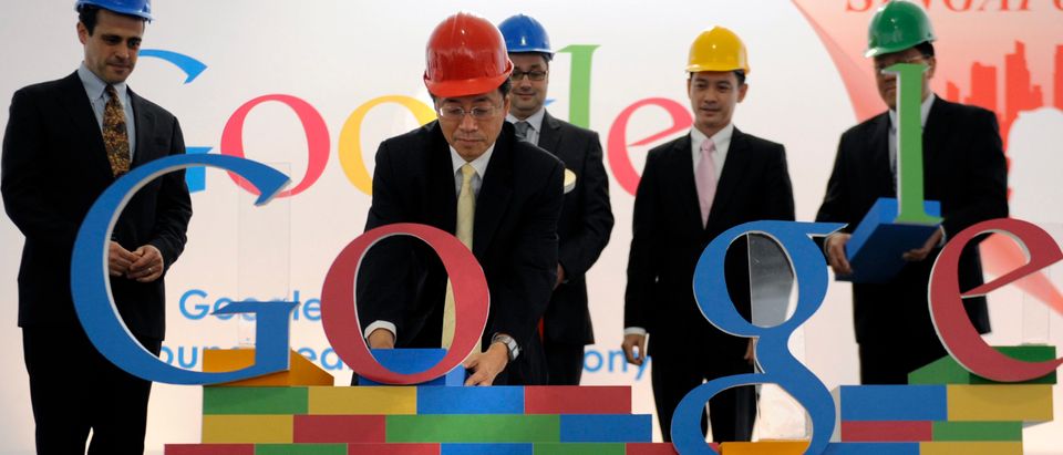 Google executive places 'O' on brick wall display.