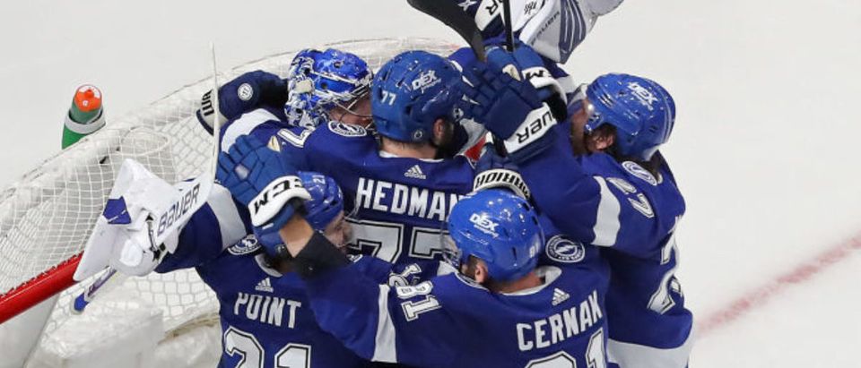 TAMPA, FLORIDA - JUNE 25: The Tampa Bay Lightning celebrate after defeating the New York Islanders 1-0 in Game Seven of the NHL Stanley Cup Semifinals during the 2021 NHL Stanley Cup Finals at Amalie Arena on June 25, 2021 in Tampa, Florida. (Photo by Mike Carlson/Getty Images)