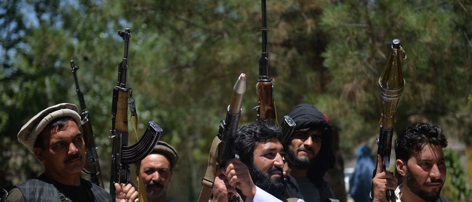 People gather with their heavy weapons to support Afghanistan security forces against the Taliban, in Guzara district, Herat province on June 23, 2021. (Photo by HOSHANG HASHIMI/AFP via Getty Images)