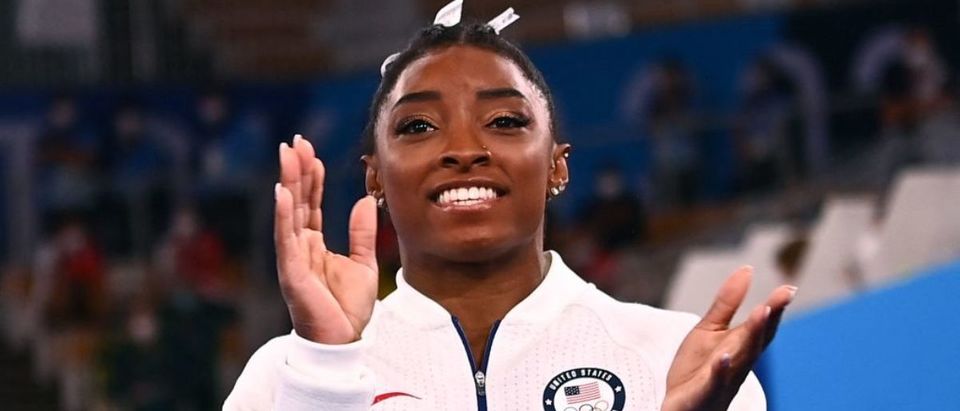 TOPSHOT - USA's Simone Biles applauds during the artistic gymnastics women's team final during the Tokyo 2020 Olympic Games at the Ariake Gymnastics Centre in Tokyo on July 27, 2021. (Photo by LOIC VENANCE/AFP via Getty Images)