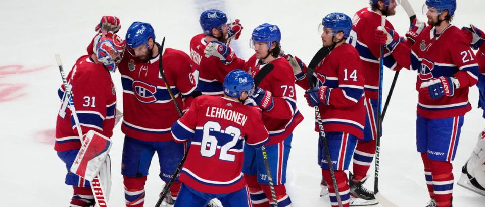 MONTREAL, QUEBEC - JULY 05: The Montreal Canadiens celebrate their 3-2 win during the first overtime period against the Tampa Bay Lightning in Game Four of the 2021 NHL Stanley Cup Final at the Bell Centre on July 05, 2021 in Montreal, Quebec, Canada. (Photo by Mark Blinch/Getty Images)