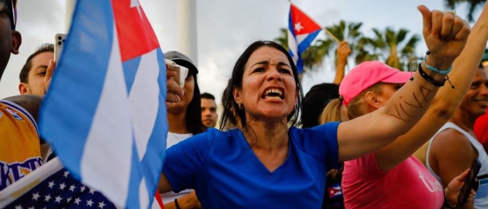 A woman chants slogans during a protest against the Cuban government at Versailles Restaurant in Miami, on July 12, 2021. - Havana on Monday blamed a US "policy of economic suffocation" for unprecedented protests against Cuba's communist government as Washington pointed the finger at "decades of repression" in the one-party state. (Photo by EVA MARIE UZCATEGUI/AFP via Getty Images)
