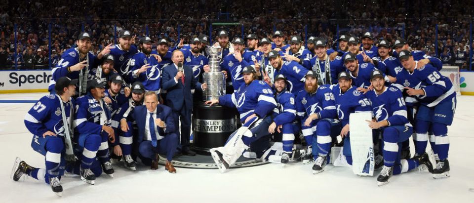 TAMPA, FLORIDA - JULY 07: The Tampa Bay Lightning pose with the Stanley Cup after defeating the Montreal Canadiens 1-0 in Game Five to win the 2021 NHL Stanley Cup Final at Amalie Arena on July 07, 2021 in Tampa, Florida. (Photo by Bruce Bennett/Getty Images)