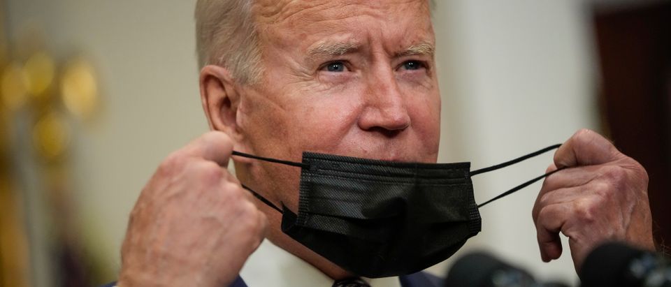 WASHINGTON, DC - AUGUST 24: U.S. President Joe Biden removes his mask as he arrives to speak about the situation in Afghanistan in the Roosevelt Room of the White House on August 24, 2021 in Washington, DC. Biden discussed the ongoing evacuations in Afghanistan, saying the U.S. has evacuated over 70,000 people from the country. (Photo by Drew Angerer/Getty Images)
