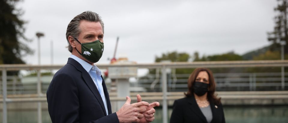 U.S. Vice President Kamala Harris looks on as California Gov. Gavin Newsom speaks while touring the Upper San Leandro Water Treatment Plant on April 5, 2021 in Oakland, California. (Photo by Justin Sullivan/Getty Images)