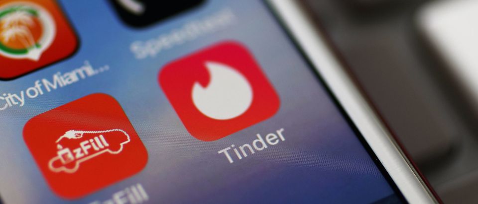 In this photo illustration, the icon for the dating app Tinder is seen on the screen of an iPhone on August 14, 2018 in Miami, Florida. (Photo illustration by Joe Raedle/Getty Images)