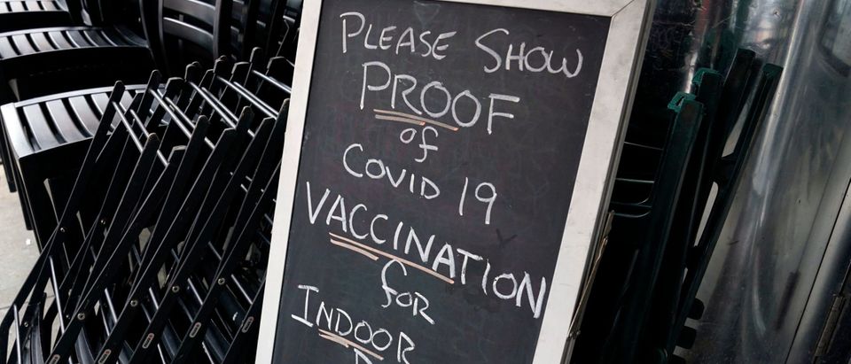 A sign is viewed at a restaurant in New York's Upper West Side on August 17, 2021, the first day where you have to show proof of having a Covid-19 vaccination to participate in indoor dining. (Photo by TIMOTHY A. CLARY/AFP via Getty Images)
