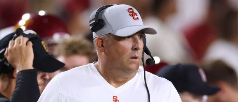LOS ANGELES, CALIFORNIA - SEPTEMBER 11: Head coach Clay Helton of USC Trojans reacts as Kedon Slovis #9 comes off the field to punt on fourth down during the first quarter against the Stanford Cardinal at Los Angeles Memorial Coliseum on September 11, 2021 in Los Angeles, California. (Photo by Harry How/Getty Images)