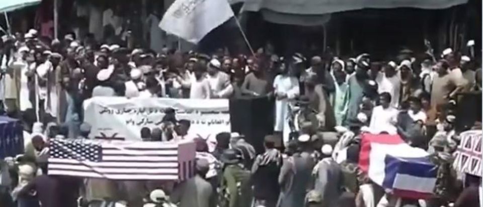 Taliban supporters hold a mock funeral with coffins draped with the American flag. (Screenshot/Twitter/Zhman TV and Sky News)