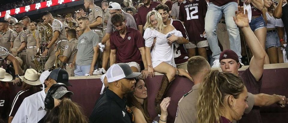 COLLEGE STATION, TEXAS - OCTOBER 09: Texas A&amp;M Aggies fans storm the field after defeating the Alabama Crimson Tide 41-38 at Kyle Field on October 09, 2021 in College Station, Texas. (Photo by Bob Levey/Getty Images)