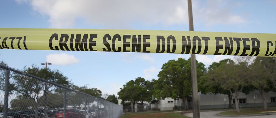 PARKLAND, FL - FEBRUARY 23: Crime scene tape is seen outside Marjory Stoneman Douglas High School as teachers and staff are allowed to return to the school for the first time since the mass shooting on campus on February 23, 2018 in Parkland, Florida. Police arrested 19-year-old former student Nikolas Cruz for killing 17 people at the high school. (Photo by Joe Raedle/Getty Images)