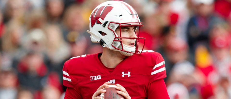 Oct 30, 2021; Madison, Wisconsin, USA; Wisconsin Badgers quarterback Graham Mertz (5) drops back to pass during the third quarter against the Iowa Hawkeyes at Camp Randall Stadium. Mandatory Credit: Jeff Hanisch-USA TODAY Sports via Reuters