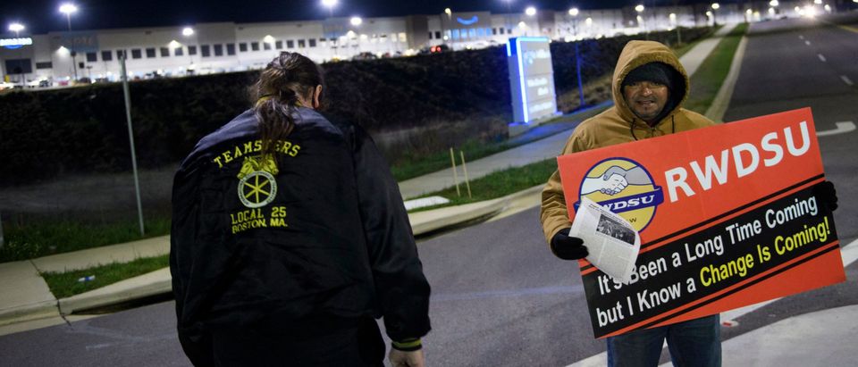 Union supporters distribute information before sunrise outside of the Amazon.com, Inc. BHM1 fulfillment center on March 29, 2021 in Bessemer, Alabama. (Photo by PATRICK T. FALLON/AFP via Getty Images)