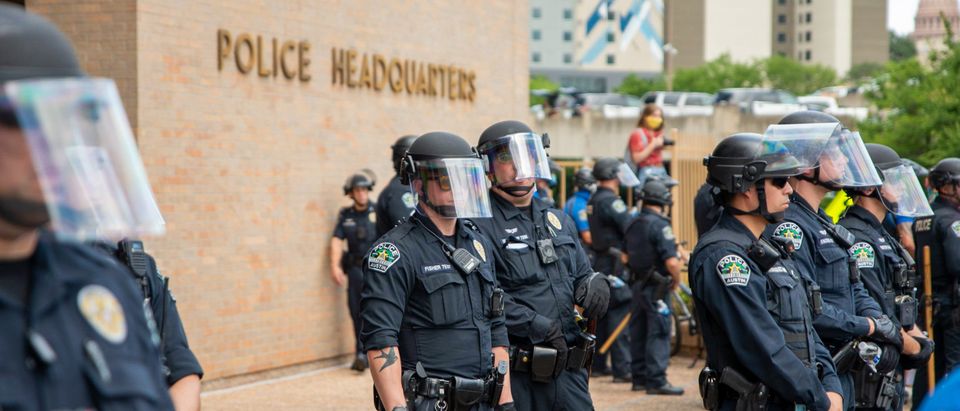 Austin Police Department officers stand outside headquarters during a police protest [Shutterstock/ Poli Pix Co. LLC]