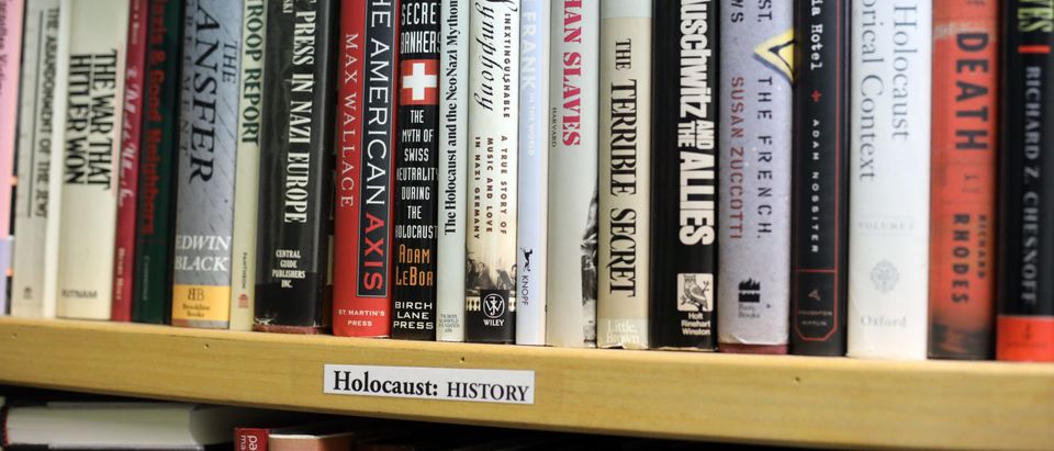 A book shelf with Holocaust-centered books [Shutterstock/photo-denver]