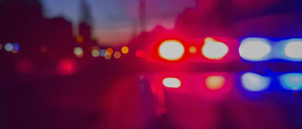 Red and blue police lights flash. [Shutterstock/Yevhen Prozhyrko]