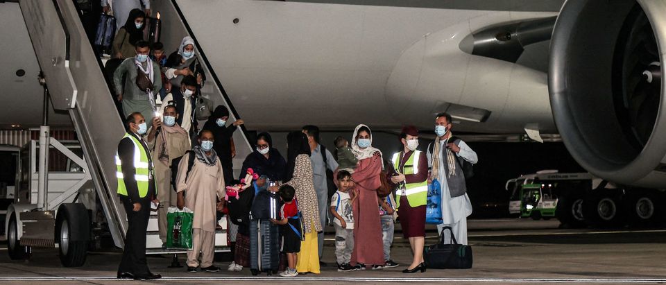 TOPSHOT - Evacuees from Afghanistan, including US citizens, arrive at Hamad International Airport in Qatar's capital Doha on the first flight carrying foreigners out of the Afghan capital since the conclusion of the US withdrawal last month, September 9, 2021. - Around 100 passengers including Americans arrived in Doha after flying from Kabul airport on September 9, the first flight ferrying out foreigners since the US-led chaotic airlift of more than 120,000 people concluded on August 30. (Photo by KARIM JAAFAR / AFP) (Photo by KARIM JAAFAR/AFP via Getty Images)