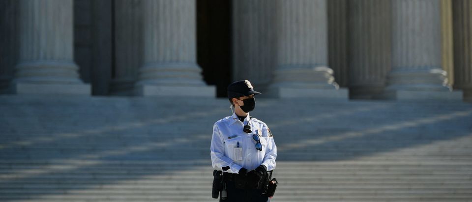 A member of the Supreme Court police stands guard outside of the US Supreme Court in Washington, DC on November 1, 2021.