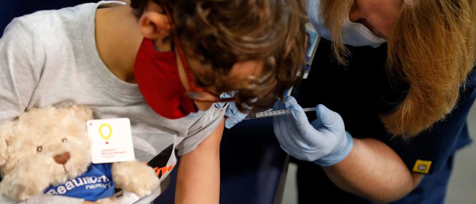 A 7 year-old child receives their first dose of the Pfizer Covid-19 vaccine at the Beaumont Health offices in Southfield, Michigan on November 5, 2021. (Photo by JEFF KOWALSKY / AFP) (Photo by JEFF KOWALSKY/AFP via Getty Images)