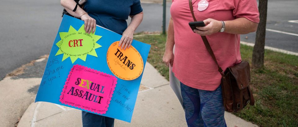 Protesters and activists stand outside a Loudoun County Public Schools (LCPS) board meeting in Ashburn, Virginia on October 12, 2021.(Photo by ANDREW CABALLERO-REYNOLDS/AFP via Getty Images)