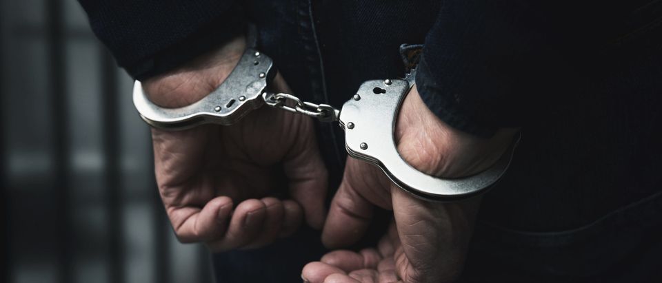 Arrested man in handcuffs. This image does not represent the officer mentioned in story. [Shutterstock/Ronstik]
