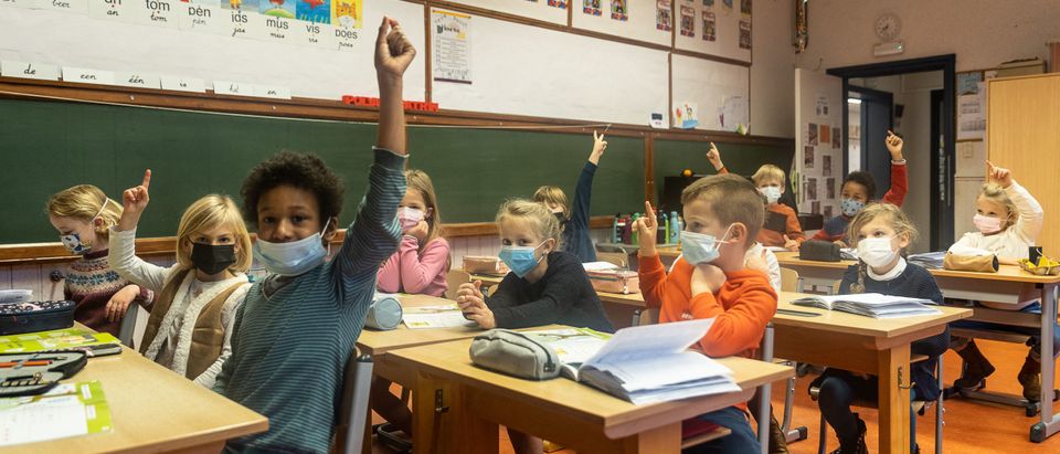 Schoolchildren wear face mask during the lesson at a elementary school in Gent, on December 6, 2021. (Photo by JAMES ARTHUR GEKIERE/Belga/AFP via Getty Images)