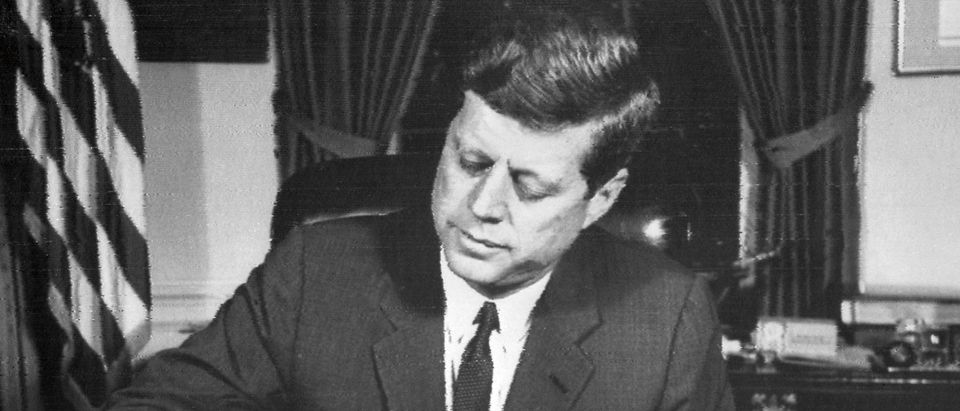 US President John Fitzgerald Kennedy signs the order of naval blockade of Cuba, on October 24, 1962 in White House, Washington DC, during the Cuban missiles crisis. On October 22, 1962, President Kennedy informed the American people of the presence of missile sites in Cuba. Tensions mounted, and the world wondered if there could be a peaceful resolution to the crisis, until November 20, 1962, when Russian bombers left Cuba, and Kennedy lifted the naval blockade. (Photo credit should read /AFP via Getty Images)